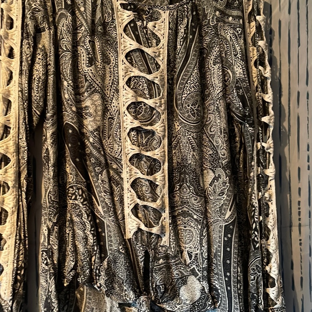 Black and white paisley dress shirt. Shows skin on arms.